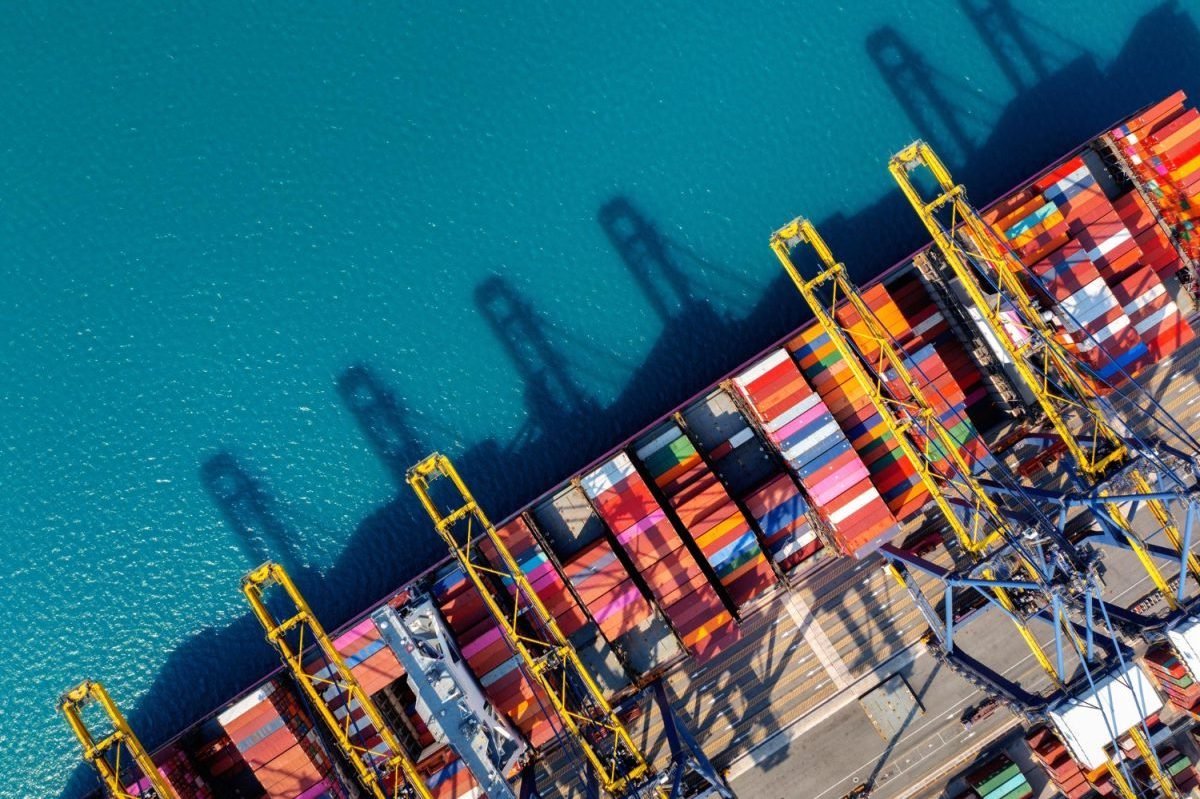 Aerial view of cargo ship and cargo container in harbor